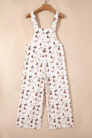 White cotton jumpsuit with desert motif, adjustable straps, and cropped wide legs.
