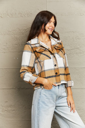 Camel plaid shacket with contrast collar, buttoned front, and chest pockets.