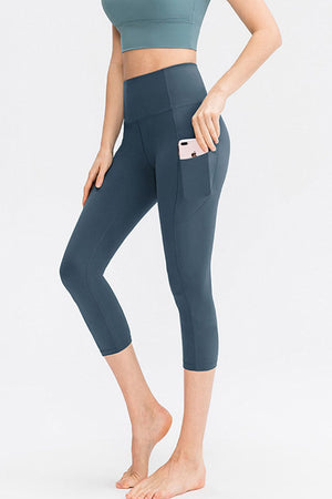 Deep Teal capri leggings with a phone pocket detail on the side.