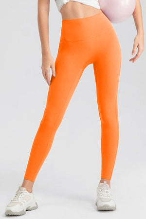Orange high-waist performance leggings with sculpting seams