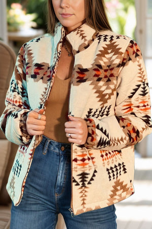 Southwestern quilted zip-up jacket in eggshell with a geometric pattern, featuring a stand-up collar and full zip closure.