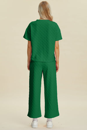 Dark green textured knit lounge set with wide leg pants and short sleeve top.