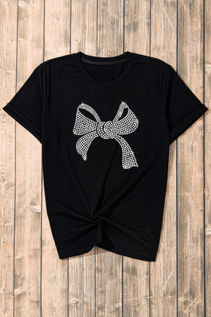 Black t-shirt with rhinestone bow graphic and knotted hem.