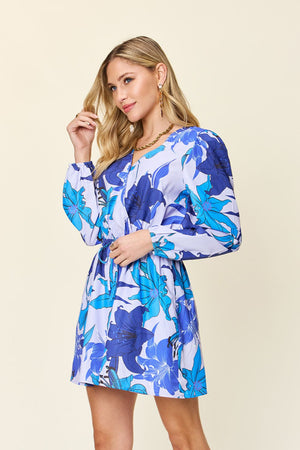 Blue floral wrap romper with long sleeves and a tie waist