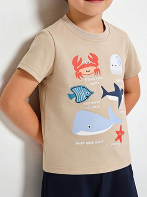 Beige cotton t-shirt with colorful ocean animal graphics including a crab, jellyfish, fish, shark, whale, and starfish.