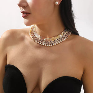 Gold-plated pearl choker necklace and stud earrings with crystal accents.