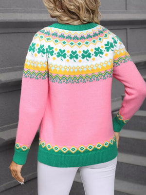 Pink knit sweater with clover and geometric pattern, green trim