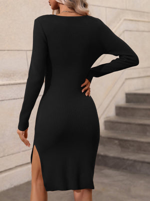 Black ribbed midi dress with long sleeves and a high slit.