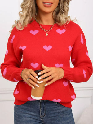 Red acrylic sweater with pink heart print, crew neck, long sleeves.