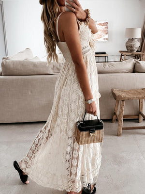 White lace V-neck maxi dress with ruffles and a tiered skirt.