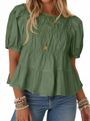 Charming puff sleeve maternity blouse in light green with ruffled tiers and smocked bodice.