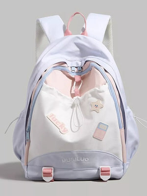 Contrasting accent drawstring backpack in white, pink, and light purple with cute patches and buckle details.