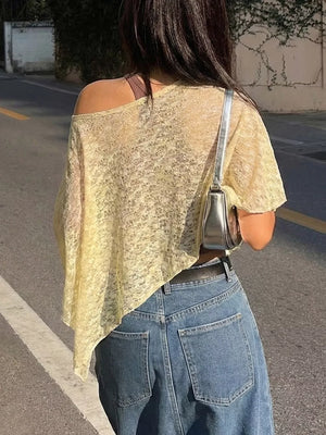 Yellow sheer one-shoulder cropped cardigan with a loose knit and asymmetrical hem.