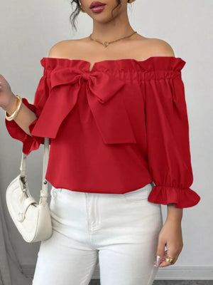 Red off-shoulder blouse with ruffled neckline, bow detail, and ruffled sleeves.