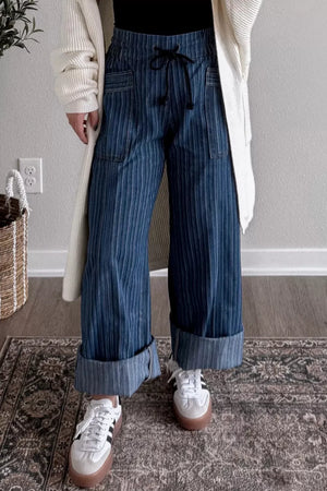 Dark striped wide-leg maternity jeans with drawstring and cuffed hems.