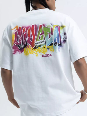 White cotton t-shirt with bold, colorful graffiti graphic print on back.
