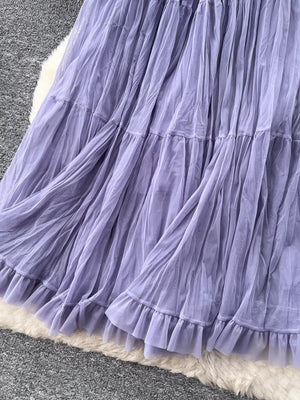 Purple tiered tulle skirt with ruffled hem and lining, showing fabric texture.