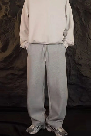 Relaxed-fit lounge trousers in dark gray with a drawstring waist and pockets.