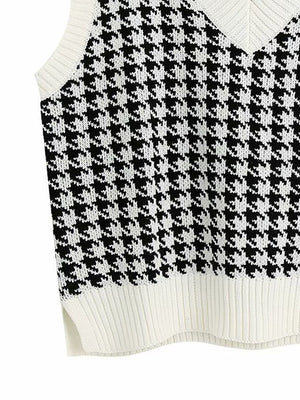 Houndstooth knit V-neck tank top in black and white with ribbed trim and side slits.