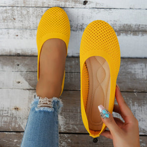 Yellow breathable knit ballet flats with perforated detail and cushioned insole.