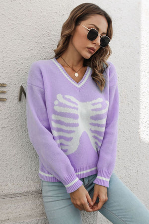 Lavender v-neck knit sweater with white ribcage graphic and striped cuffs.