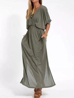 Army green V-neck maxi dress with dolman sleeves, elastic waist, pockets, and side slits.