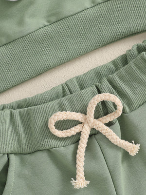 Green cotton baby outfit set with ribbed waistband and drawstring detail.