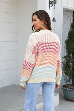 Horizontal stripe waffle knit pullover sweater with crew neck and long sleeves in apricot and white.
