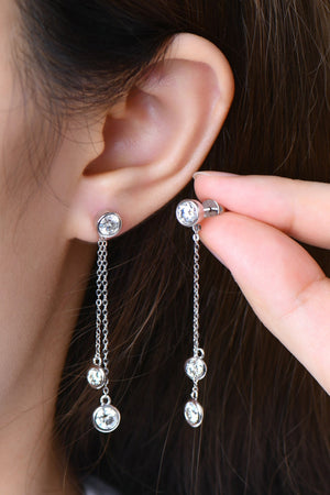 Silver cascade diamond drop earrings with multiple dangling stones and chains.