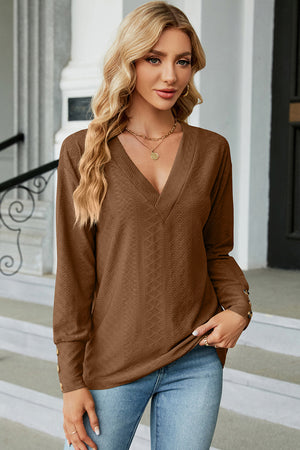 Diamond-textured V-neck blouse in mocha with button cuffs and long sleeves.