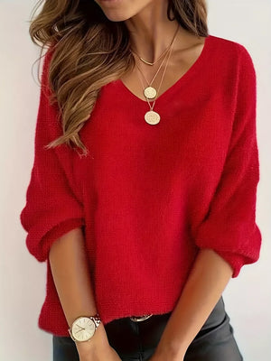 Red V-neck knit sweater with 3/4 sleeves and textured fabric.