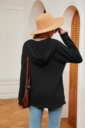 Black textured henley hoodie with drop shoulder and long sleeves.