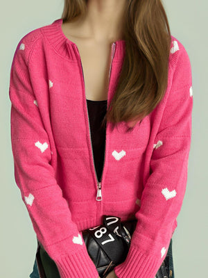 Hot Pink zip-through knit cardigan with white heart appliqué and ribbed cuffs.