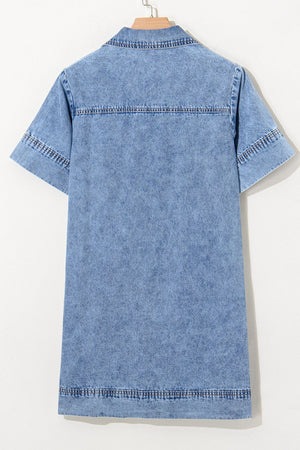 Light blue denim mini dress with short sleeves, collar, and double-stitched hem and yoke.