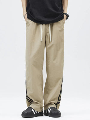 Khaki casual drawstring pants with side stripe detail and loose fit