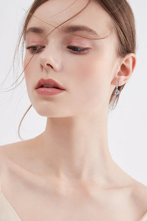 Silver drop earrings with a prism design and crystal accents.