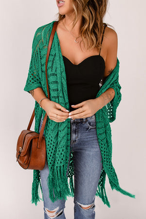 Green open knit chevron fringe cardigan with short sleeves and open front, styled with jeans and a crossbody bag.