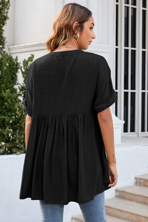 Black gathered back yoke blouse with rolled sleeves and a babydoll hem
