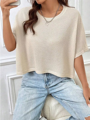Apricot waffle-knit cropped t-shirt with crew neck and short sleeves.