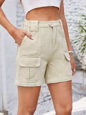 Cream utility pocket high-waist denim cargo shorts with elastic waistband and button fly.