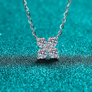 Silver four-stone moissanite clover necklace with delicate chain.