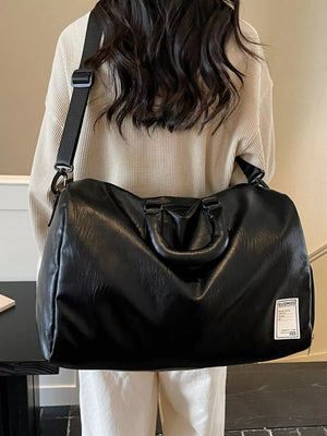 Black PU leather travel bag with top handles and adjustable shoulder strap