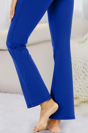 Royal Blue flare-leg performance trousers with pockets.
