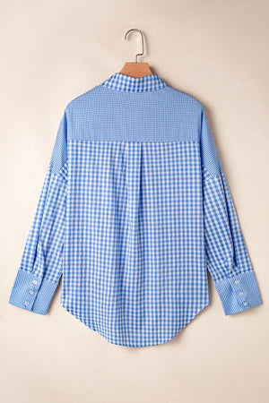 Light blue gingham oversized shirt with button cuffs and a patch pocket detail.