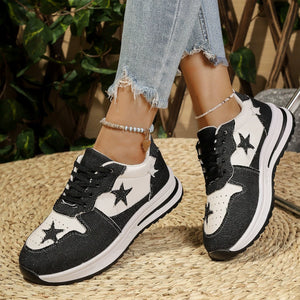 Black and white lace-up sneakers with star embellishments and a chunky sole.