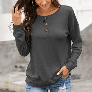 Gray henley sweatshirt with drop shoulders and a button placket.