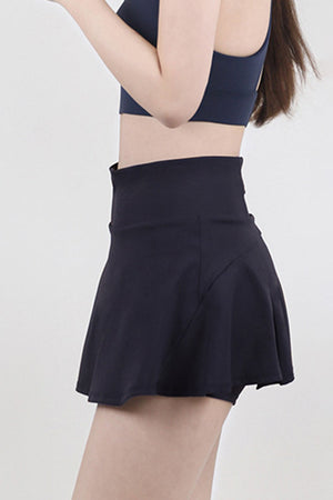 Dark blue flared skort with a high waist and built-in shorts for activewear.
