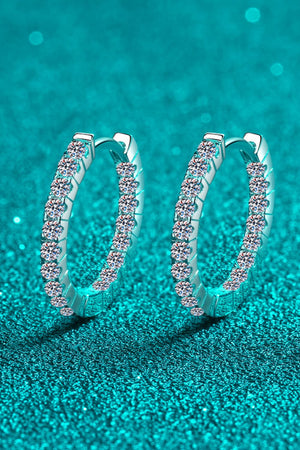 Silver pavé crystal huggie hoop earrings with sparkling stones.