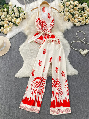 Red tropical print halter top and wide leg pants set with belted detail.