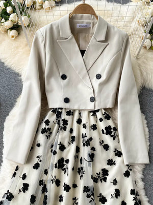 Maternity midi dress with black floral overlay and matching cream double-breasted blazer.